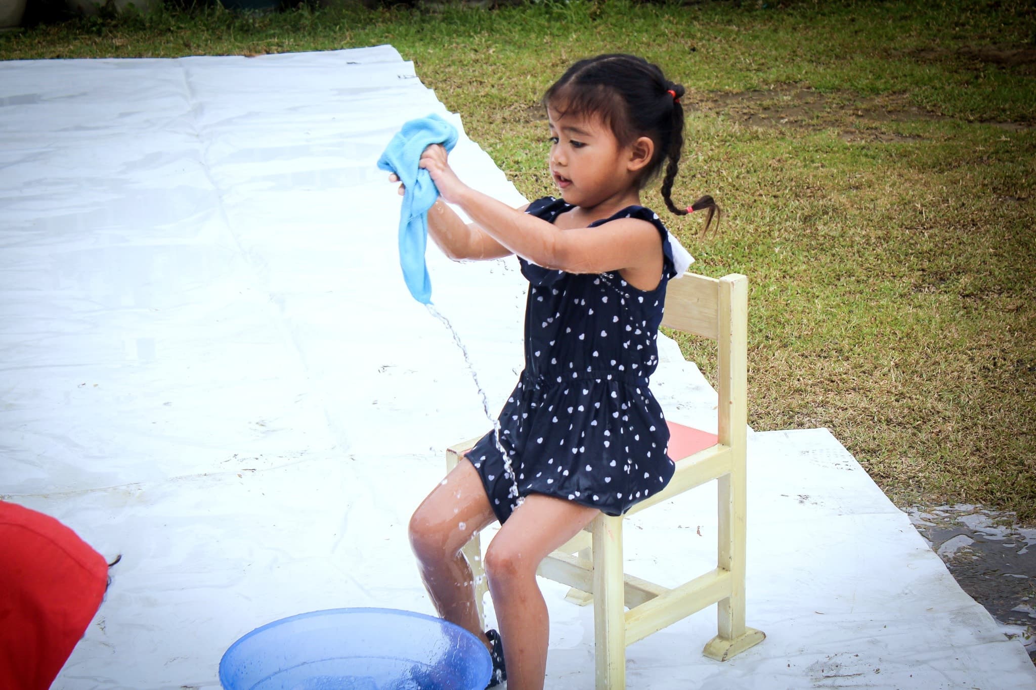 A young student at Leaders independently completing a practical water activity.