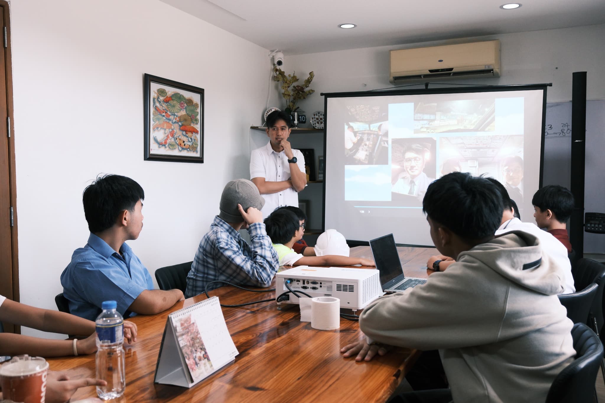 An LICSM teacher guiding older students during a group learning session.