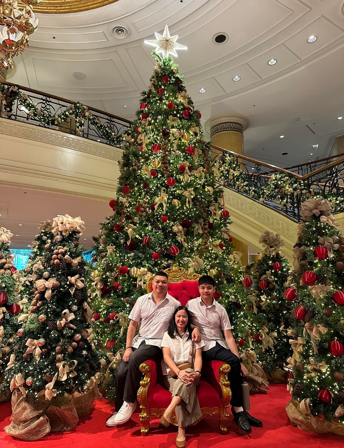 The Panopio family together in front of a Christmas tree.