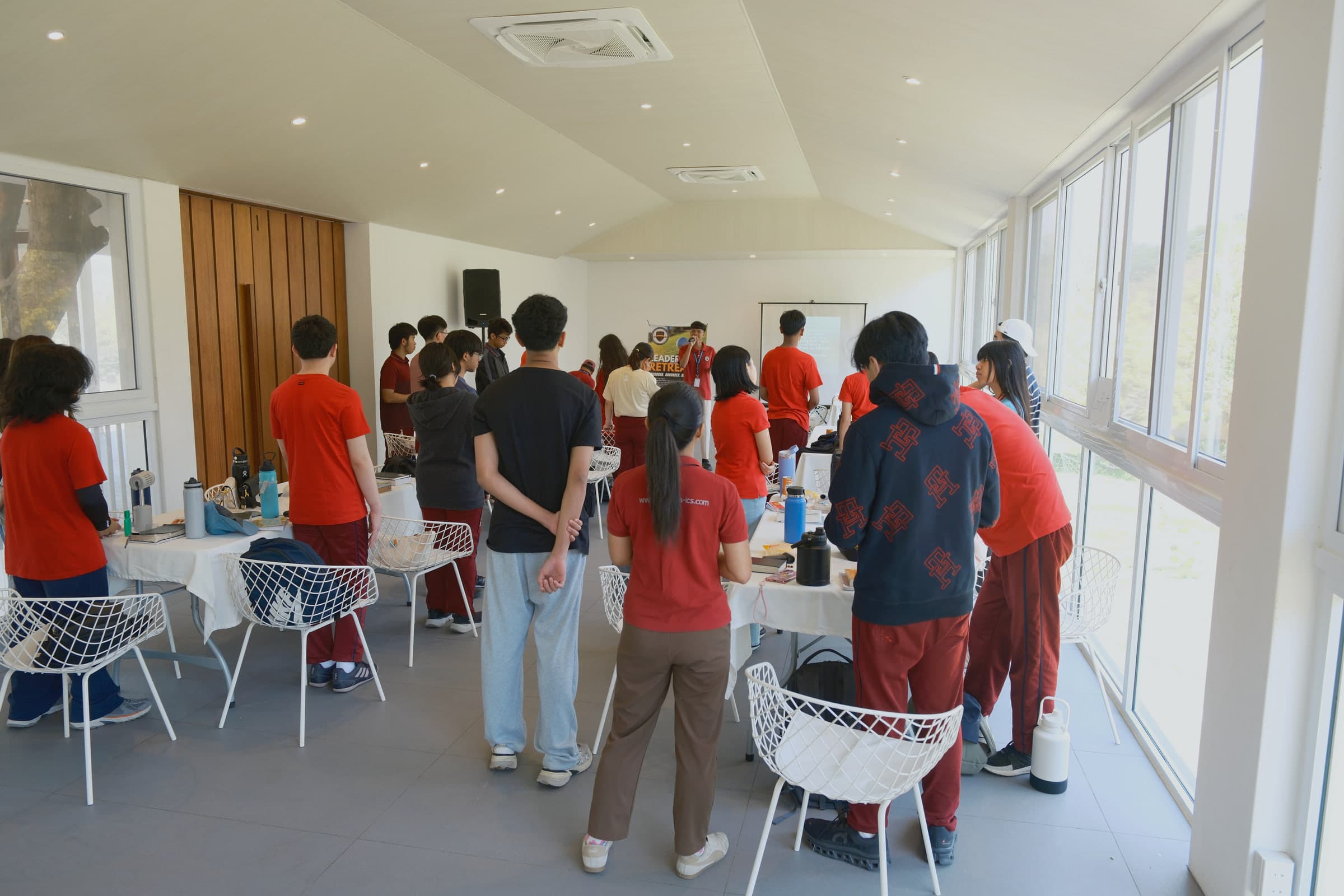 Students at Leaders participating together during a chapel gathering.