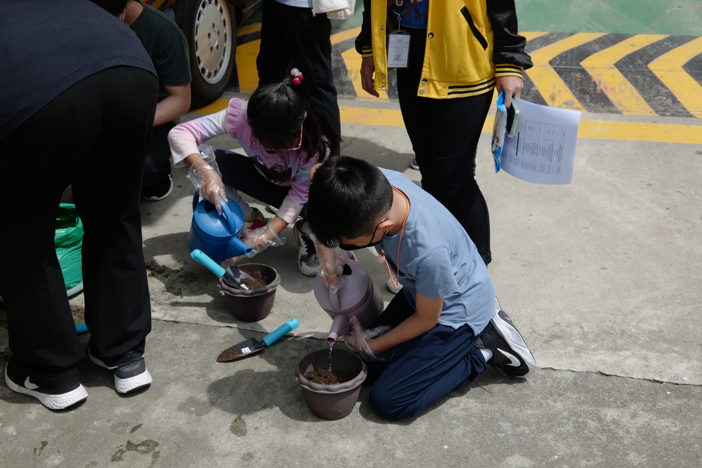 Students at Leaders planting seedlings during a hands-on learning activity.