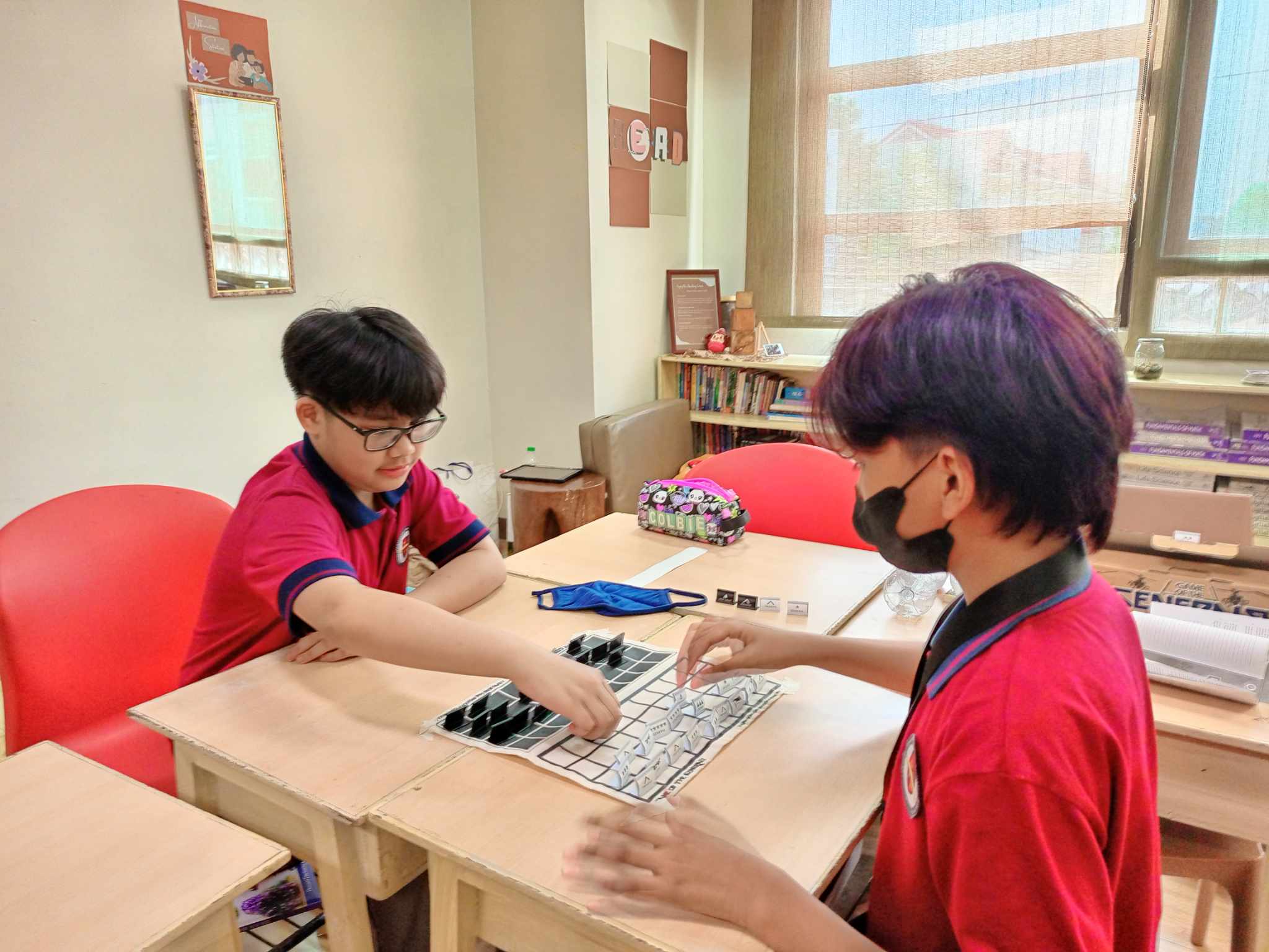 LICSM elementary students collaborating on a tabletop learning activity.