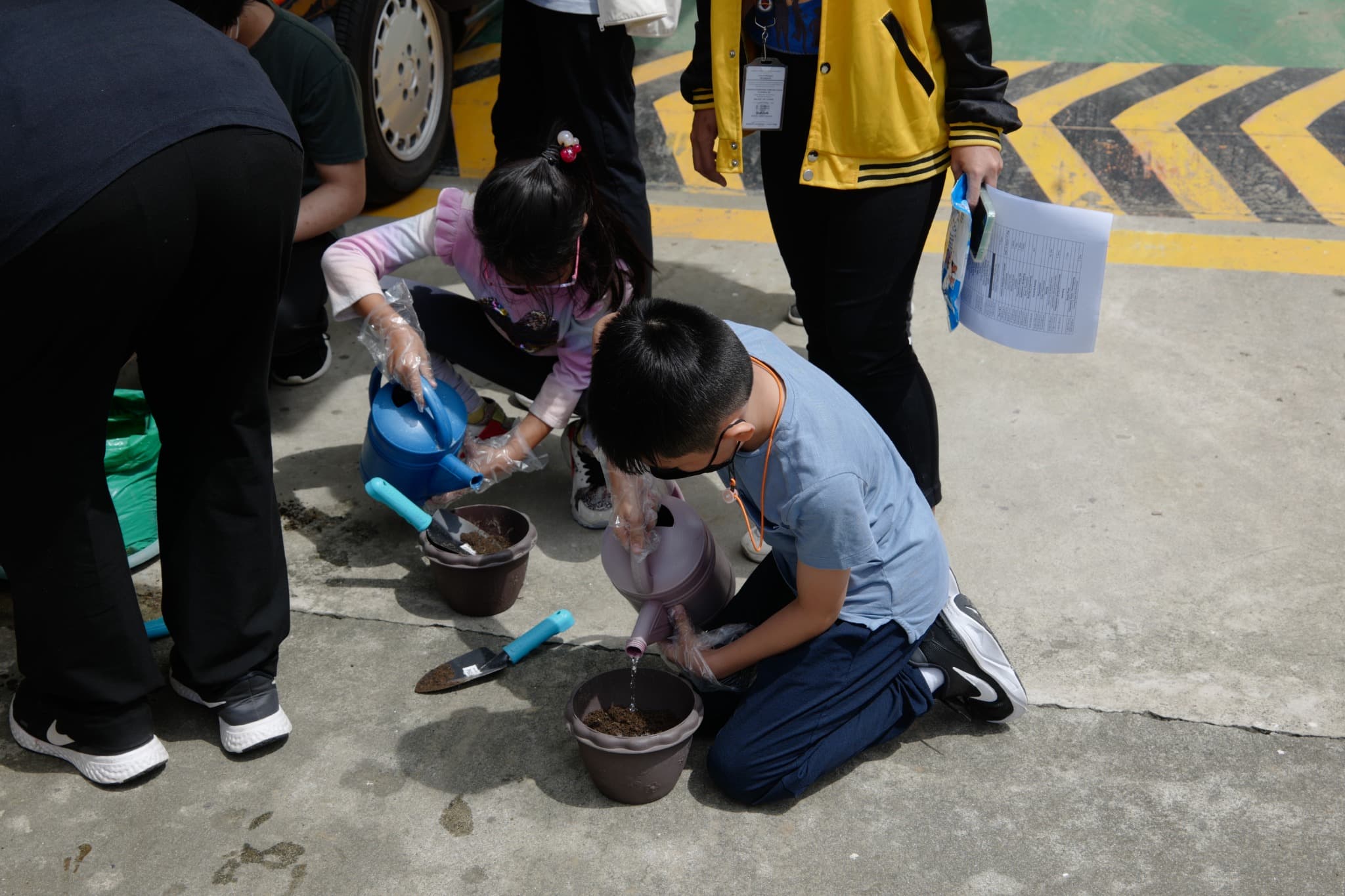 LICSM students planting seedlings during a hands-on learning activity.