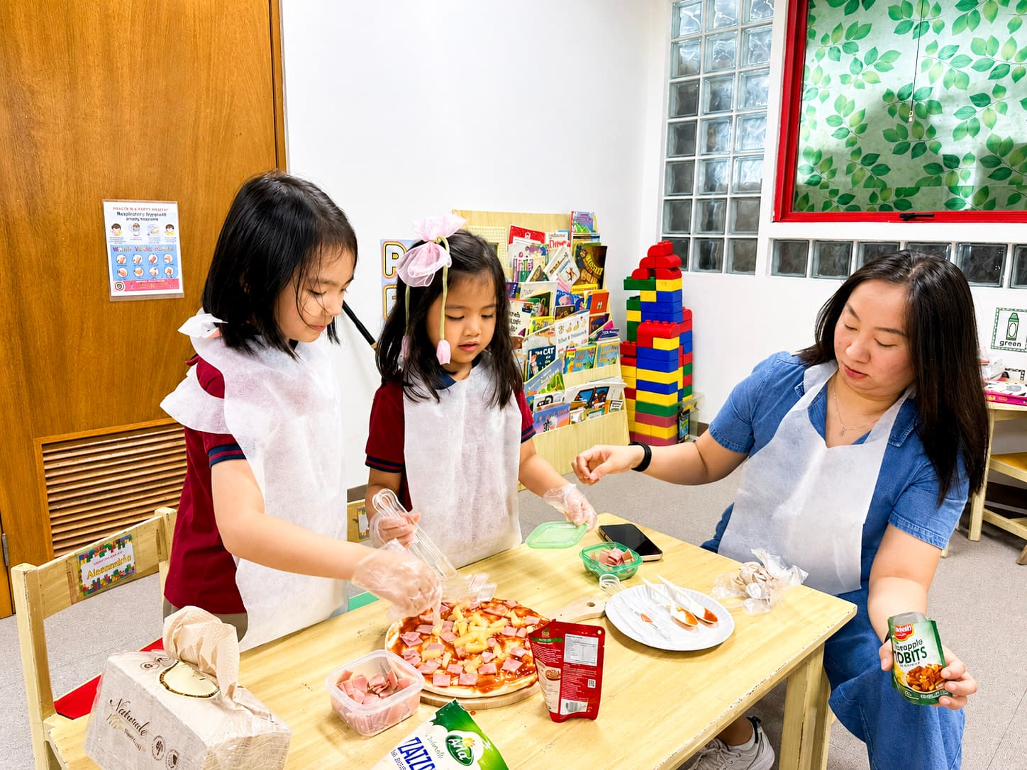 A teacher guiding preschool students through a hands-on food preparation activity.